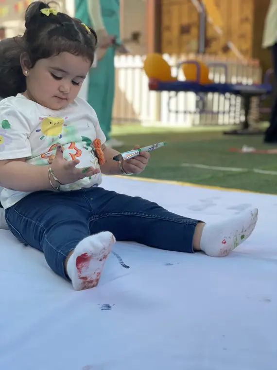Child enjoying messy floor painting